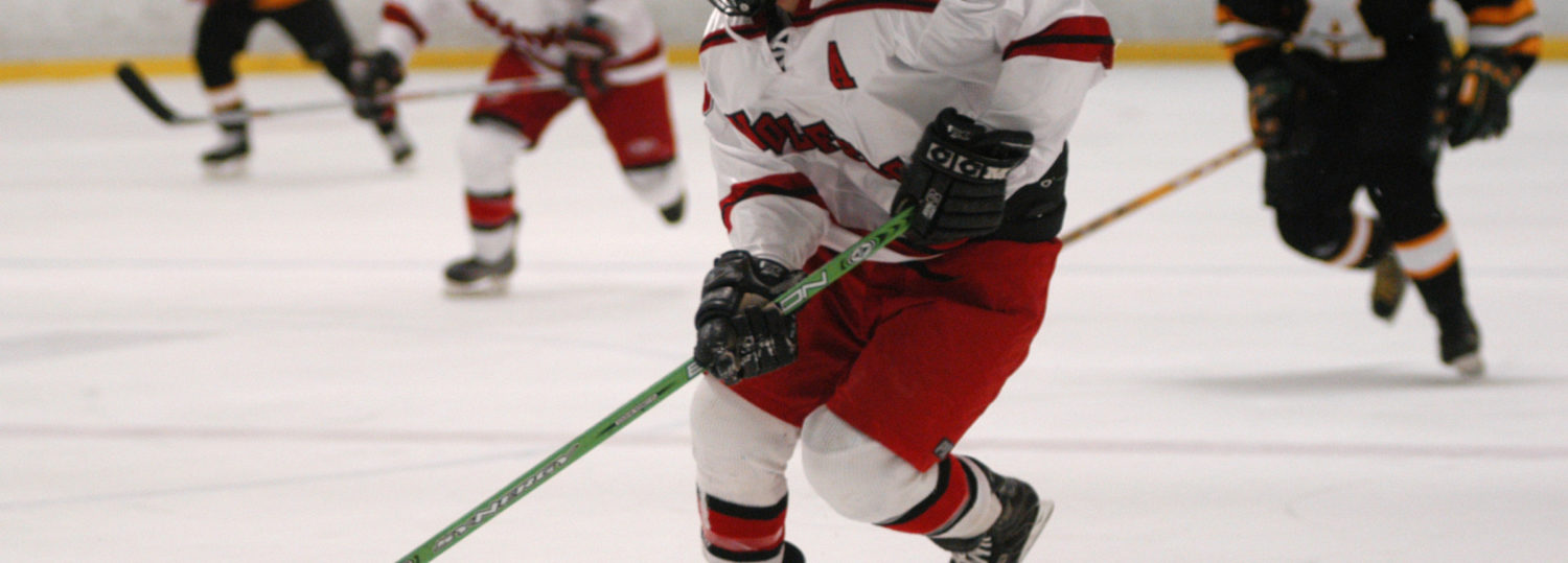 NC State hockey club player moves the puck up the ice against Appalachian State University.